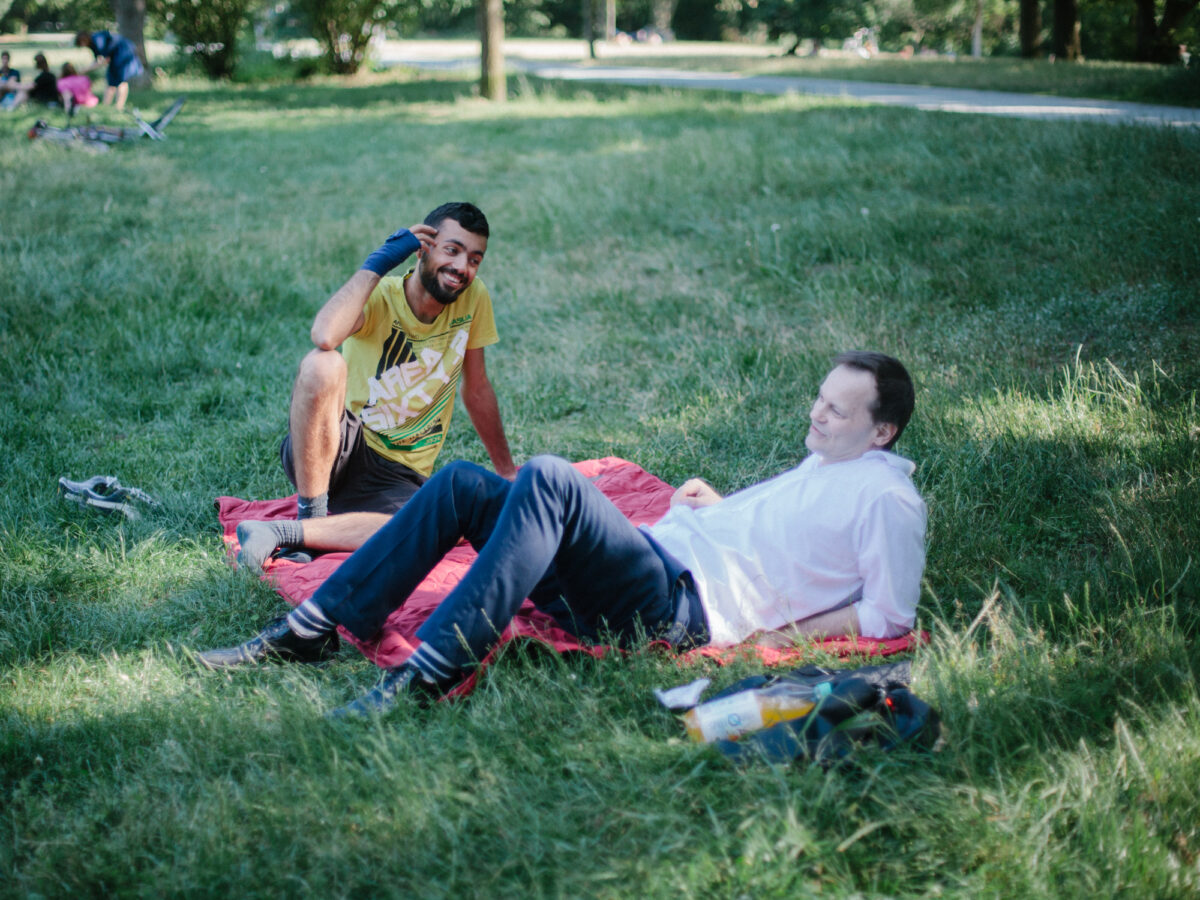 germany talks participants lying on grass